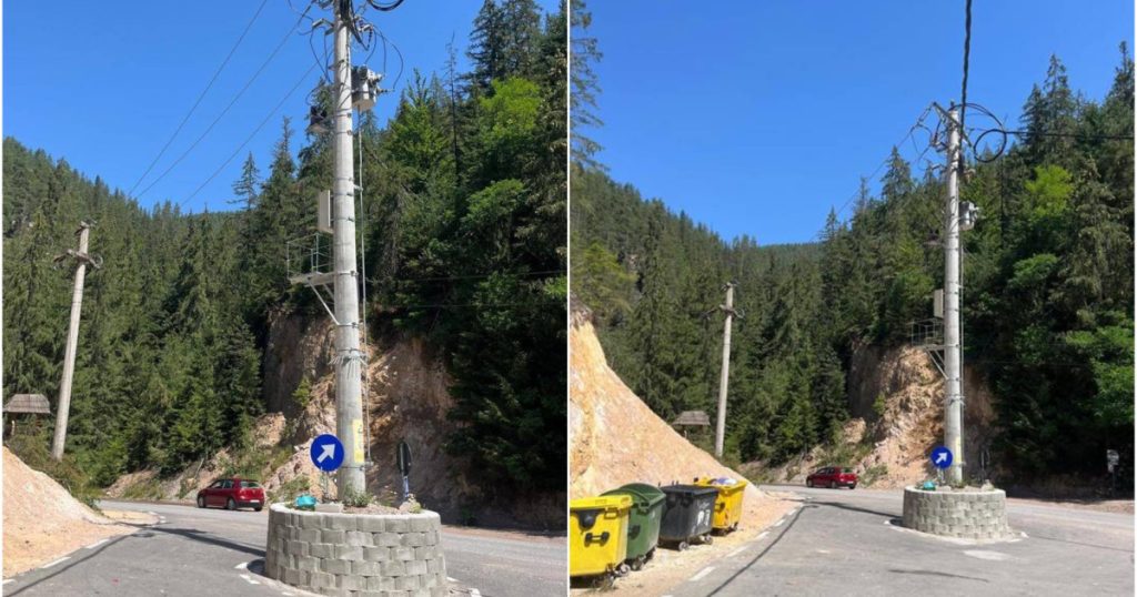 Situație absurdă în Alba: stâlp în mijlocul drumului. Constructorul a făcut un sens giratoriu în jurul lui, deși nu există intersecție